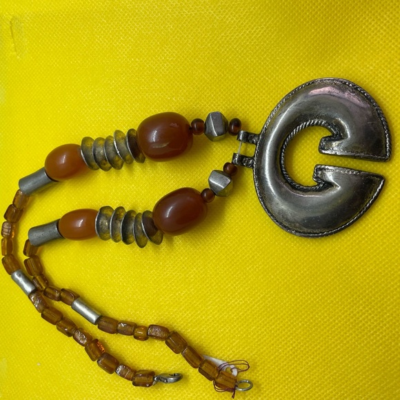 This amber and silver necklace measures 91/2 inches. - Picture 3 of 3